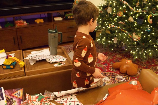 Christmas Morning Gift Opening in Festive Living Room