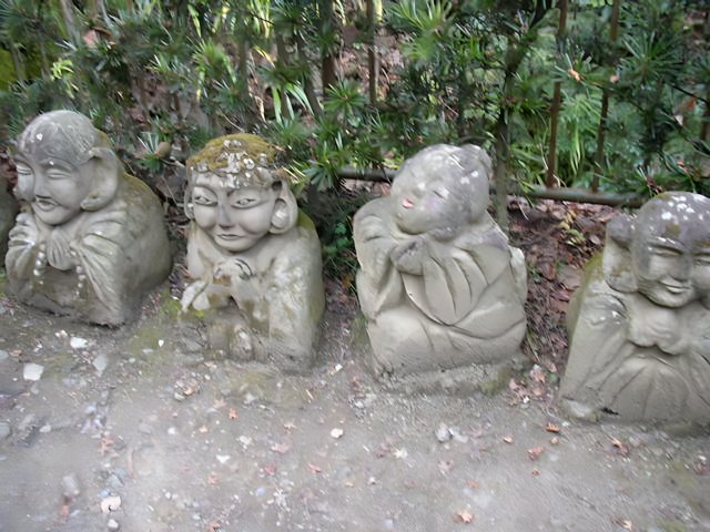 Smiling Stone Statues at Monastery Garden