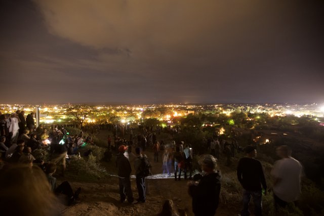 Nighttime Vigil with Urban Skyline View
