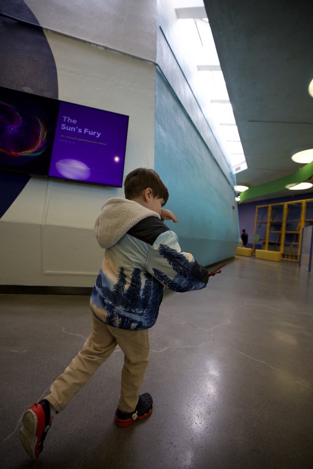 Young Boy Explores Museum with Winter Nature Jacket