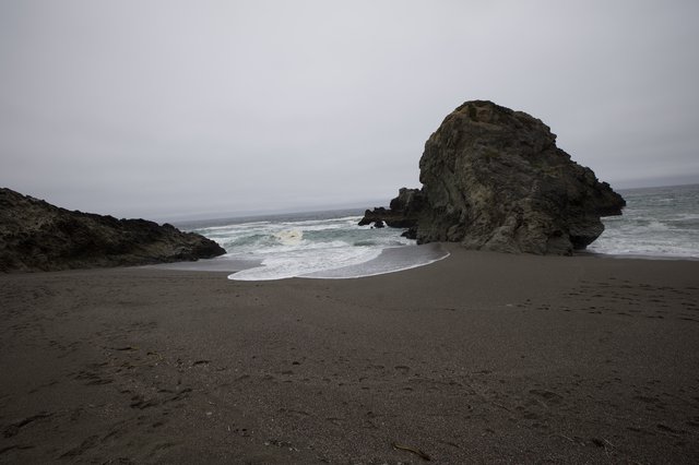 Moody Coastal Rock Formation on Foggy California Beach