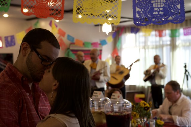A Romantic Kiss Amid Mariachi Music and Fiesta Colors