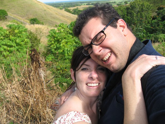 Joyful Couple Embracing on a Scenic Hillside