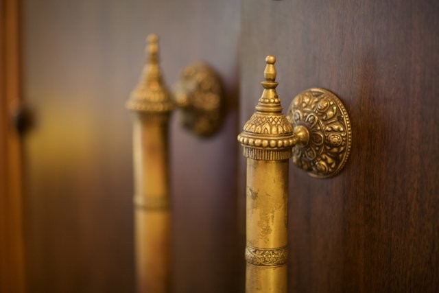 Brass Knobs on a Wooden Door
