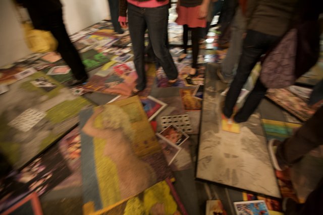 A Group Admiring Art Pieces on a Colorful Floor