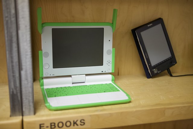 Green and White Laptop on Display
