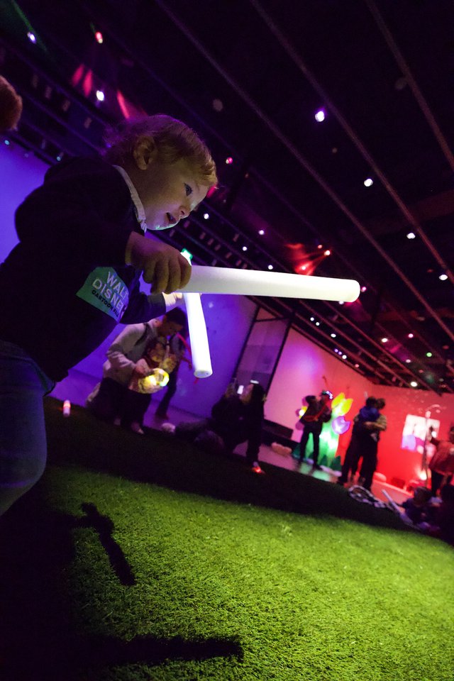 Child Playing with Light Tube at Baby Rave Event