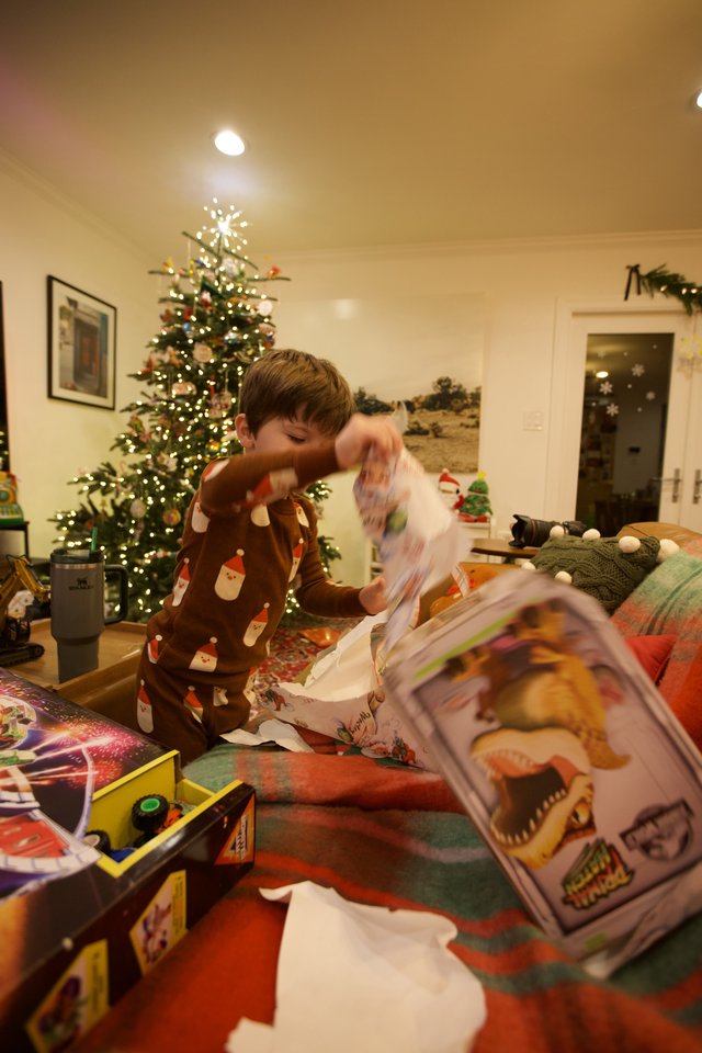 Child Opening Christmas Presents on Christmas Morning