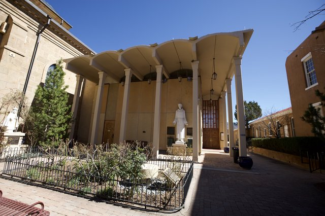 Modernist Catholic Church Entrance with Curved Canopy Architecture