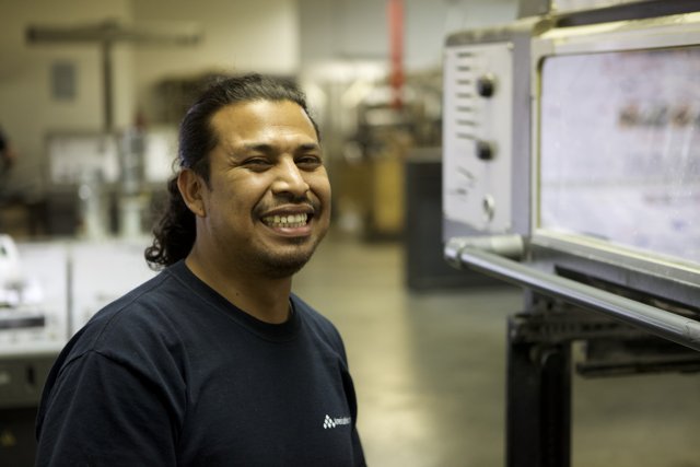 Man with a Smile in Front of Electronic Monitor