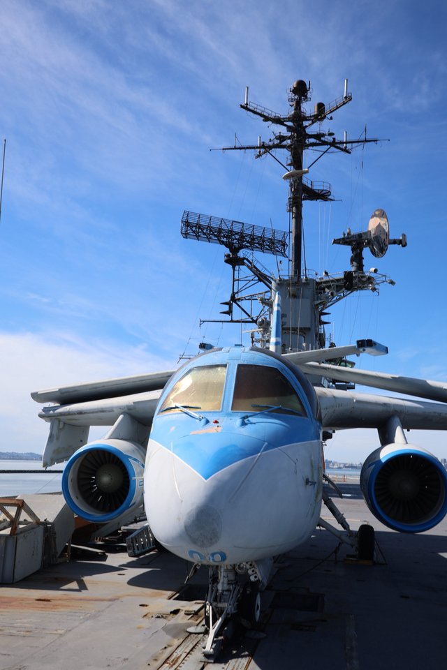 Military Aircraft on Aircraft Carrier Deck at Sunset