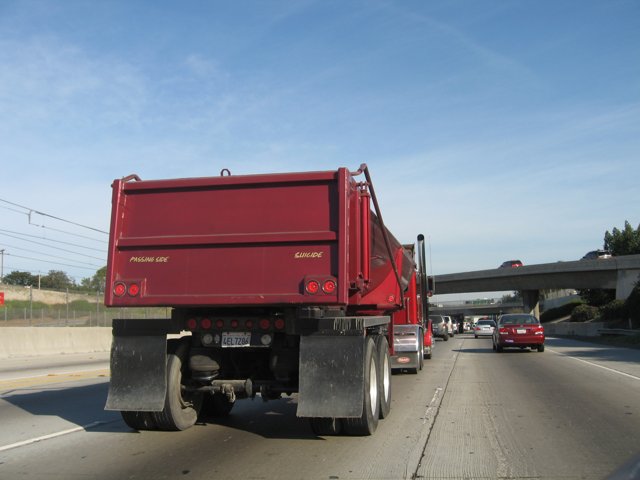Red Dump Truck Rolling Down the Road