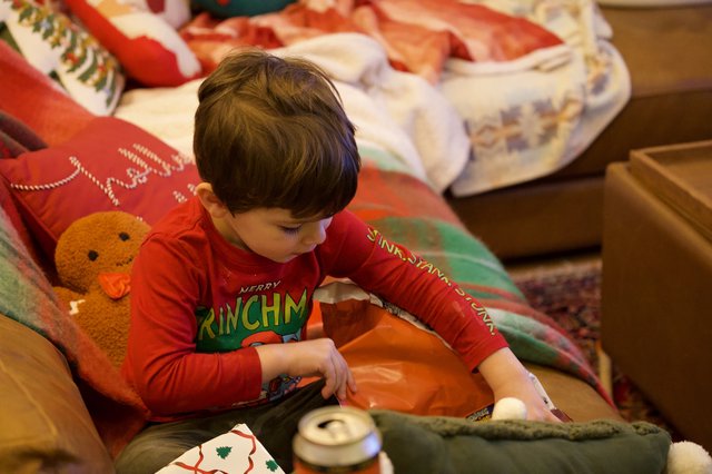 Child Opening Christmas Gift on Holiday Morning