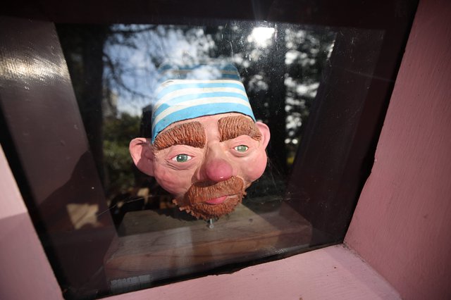 Whimsical Character Head Display in Pink Frame