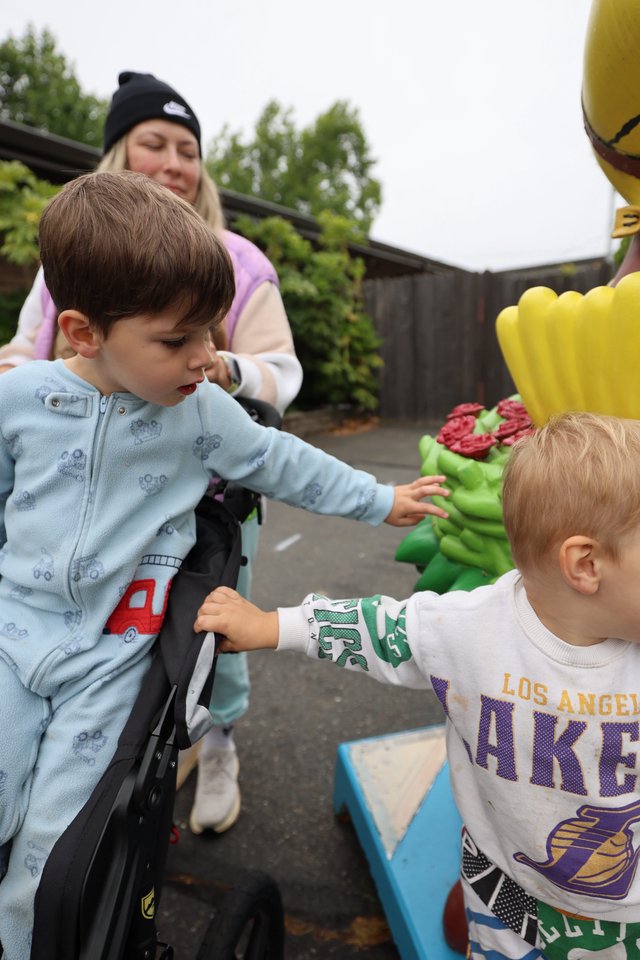 Children Discovering a Colorful Fairground Sculpture Together