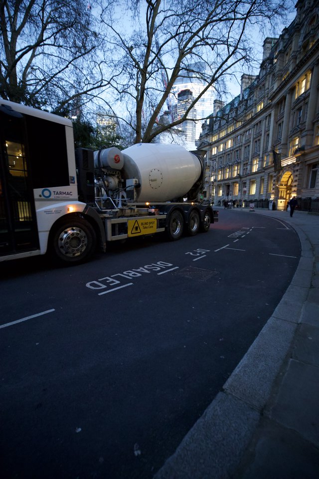 Concrete Mixer Truck Navigating Curved London Street at Dusk