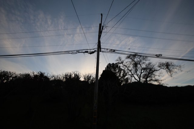 Power Lines Against Twilight Sky at Dusk