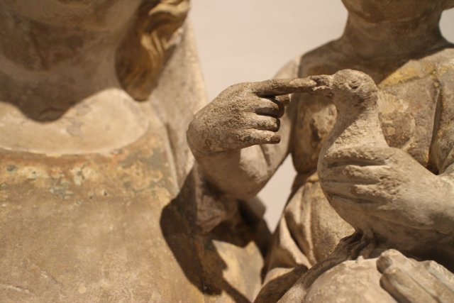 Ancient figurine of a bird-bearing woman