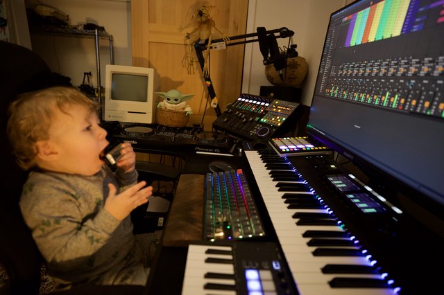 Young Child Explores Music Production Studio Setup