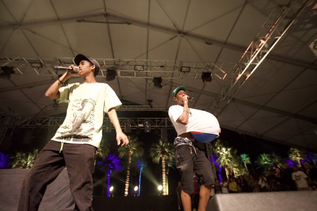 Tyler, The Creator performing on stage with a friend