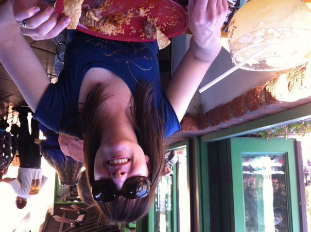 Woman Smiling Over Mexican Food at Outdoor Restaurant
