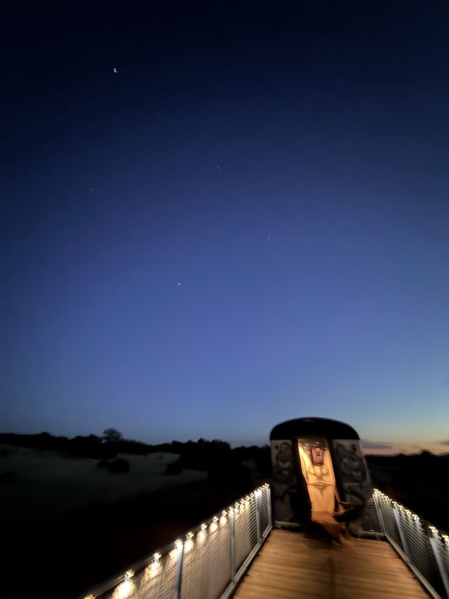 Twilight Memorial: Illuminated Walkway Under Evening Stars