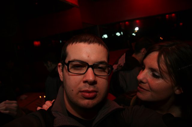 Two Friends Posing at a Dimly Lit Nightclub