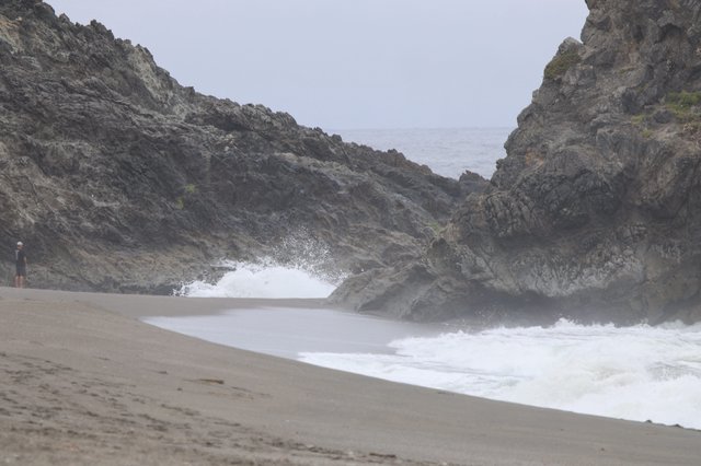 Crashing Waves Through Rocky Coastal Cliffs