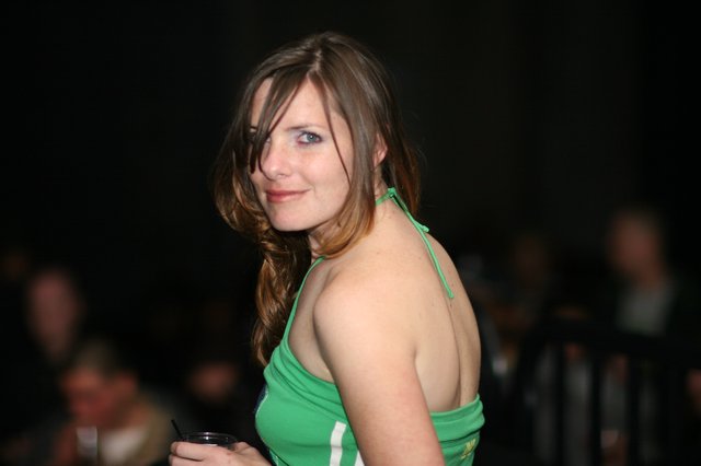 Woman in Green Halter Top at Evening Social Event