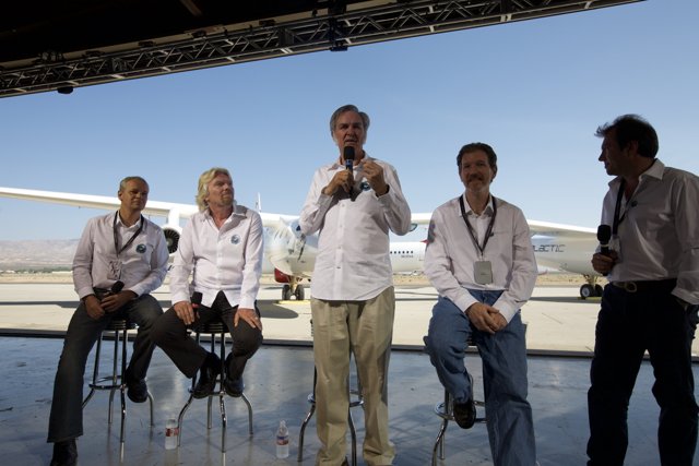 Aviation pioneers Burt Rutan and Richard Branson pose in front of White Knight Two