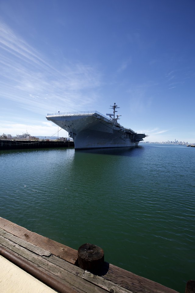 Historic Aircraft Carrier Docked in Tranquil Harbor