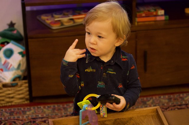 Toddler Playing with Toys on Christmas Eve