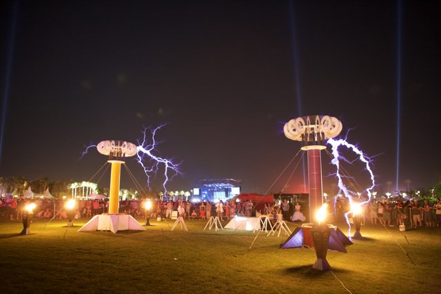 Outdoor Concert Crowd Gathers under Massive Light Pole