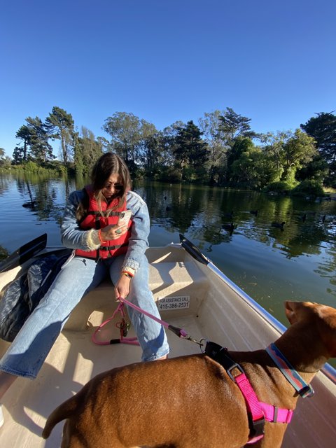 Woman and her Dog Enjoying a Leisurely Canoe Ride on the Lake
