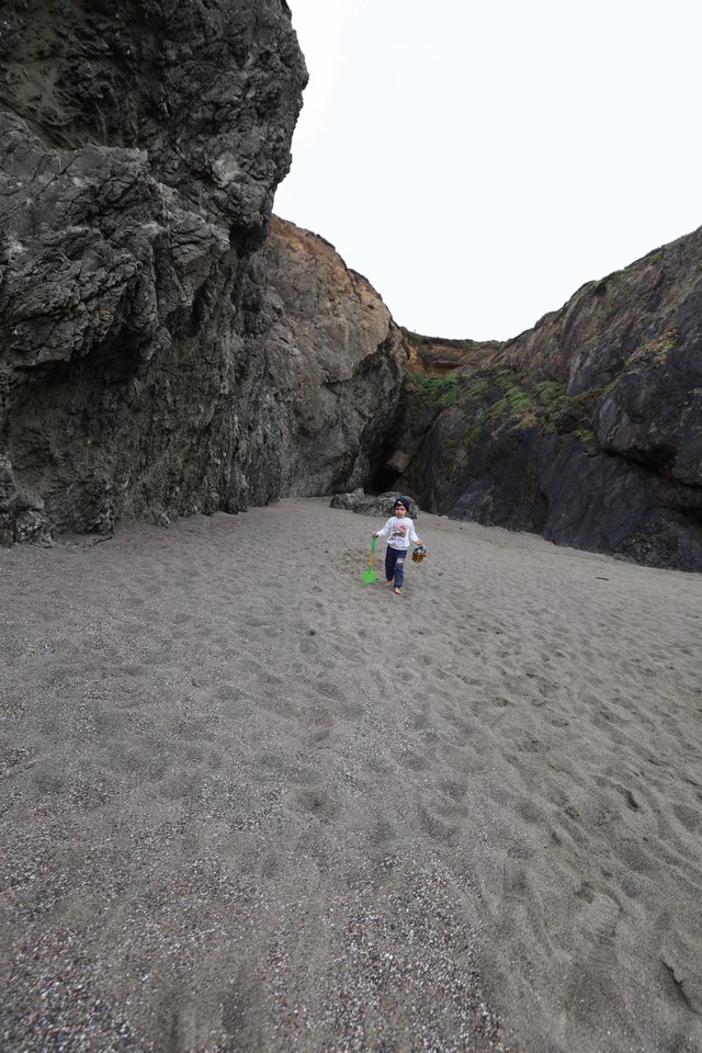 Young Explorer Roaming a Secluded Rocky Cove
