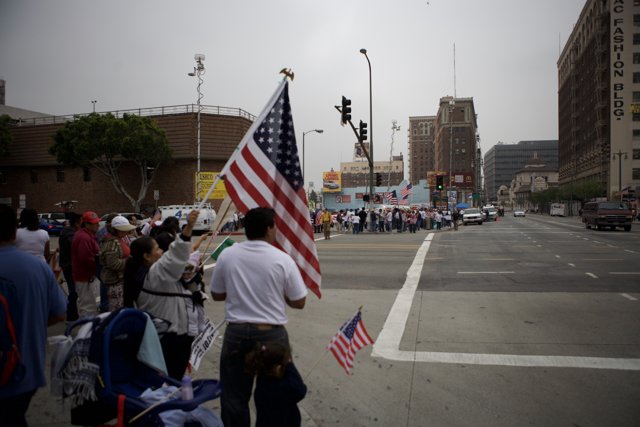 Great American Boycott Protestors Hold Two Flags on City Corner