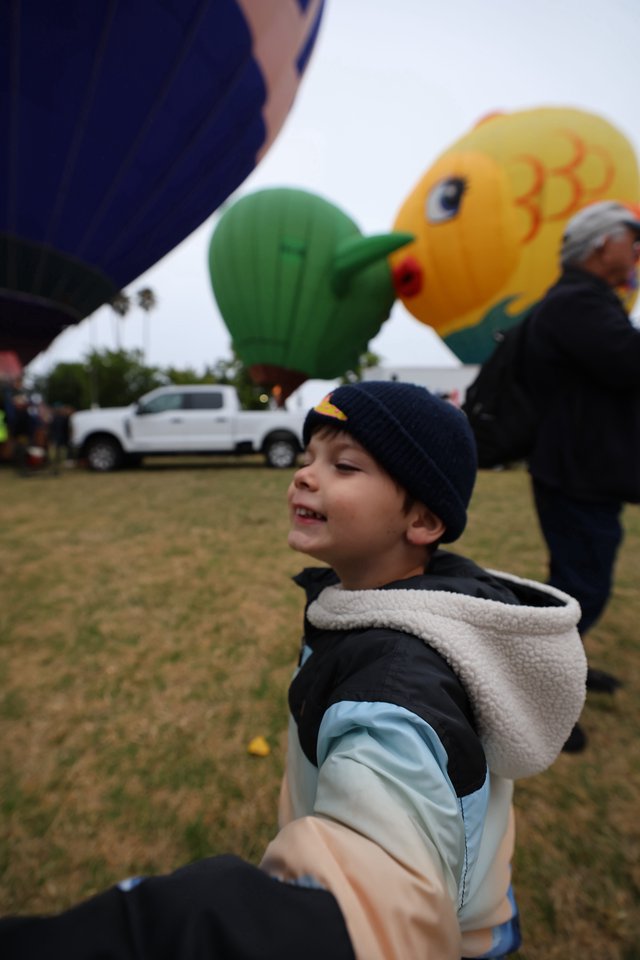 Joyful Boy Marvels at Hot Air Balloon Festival