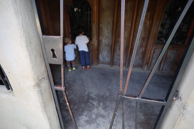 Children Entering Through Historic Church Doorway