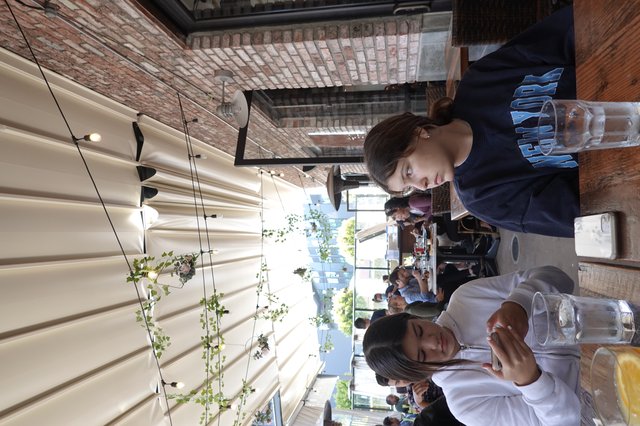 Friends Dining at Trendy Outdoor Restaurant Patio