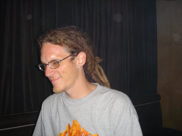 Portrait of a Man with Dreadlocks and Glasses