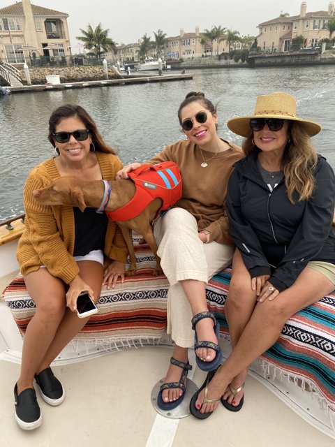 Three Women and a Dog Enjoying a Day on the Boat