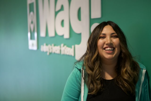 Happy Woman Poses with WAG Logo