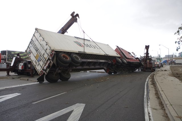 Truck Lifted by Crane on Tarmac Road