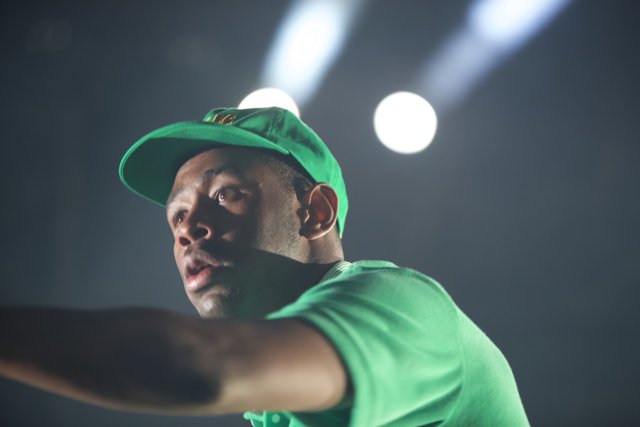 Tyler, The Creator rocks a green cap on stage