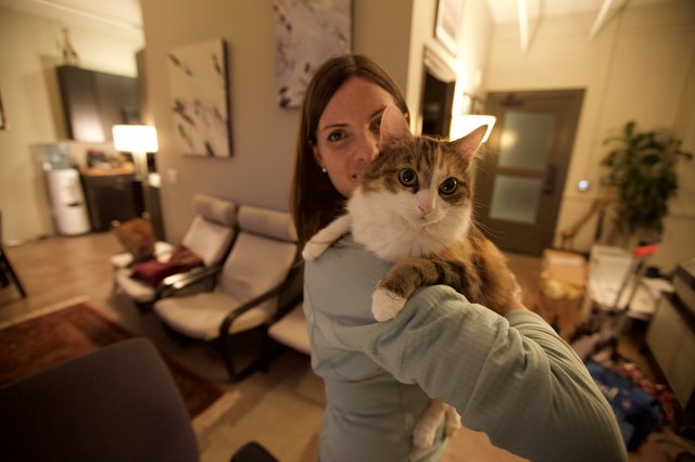 Woman Holds Fluffy Cat Up for the Camera