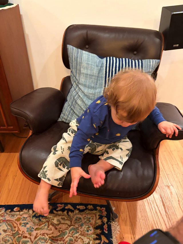 Toddler Exploring Modern Lounge Chair at Home
