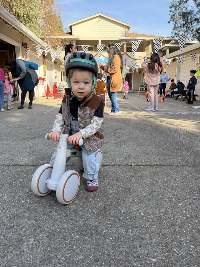 Toddler on Balance Bike at Community Event