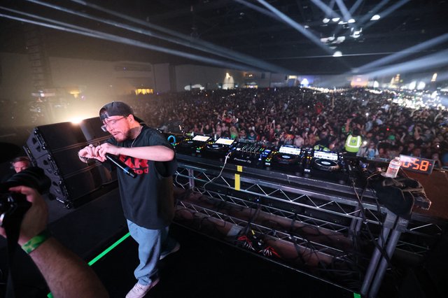 DJ Commands Massive Indoor Festival Crowd from Stage