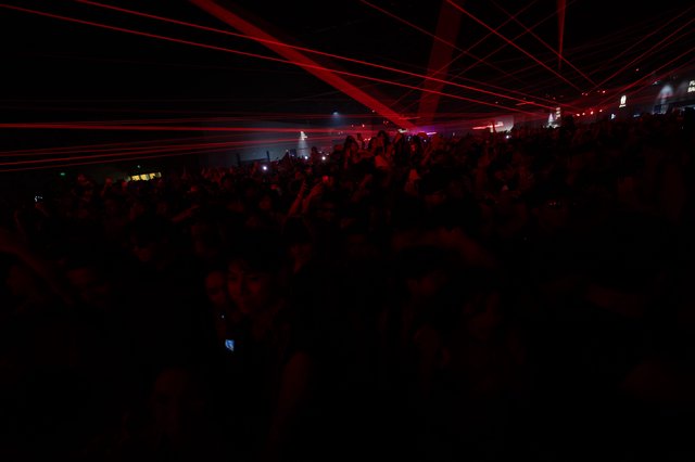 Red Laser Storm Over Pulsing Festival Crowd