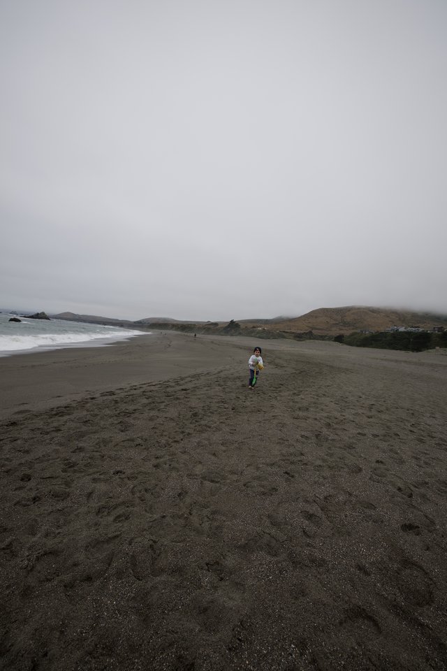 Child Running Free on Foggy Northern California Beach